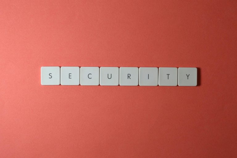 A conceptual image of the word 'security' spelled with keyboard keys on a red surface, providing copy space.